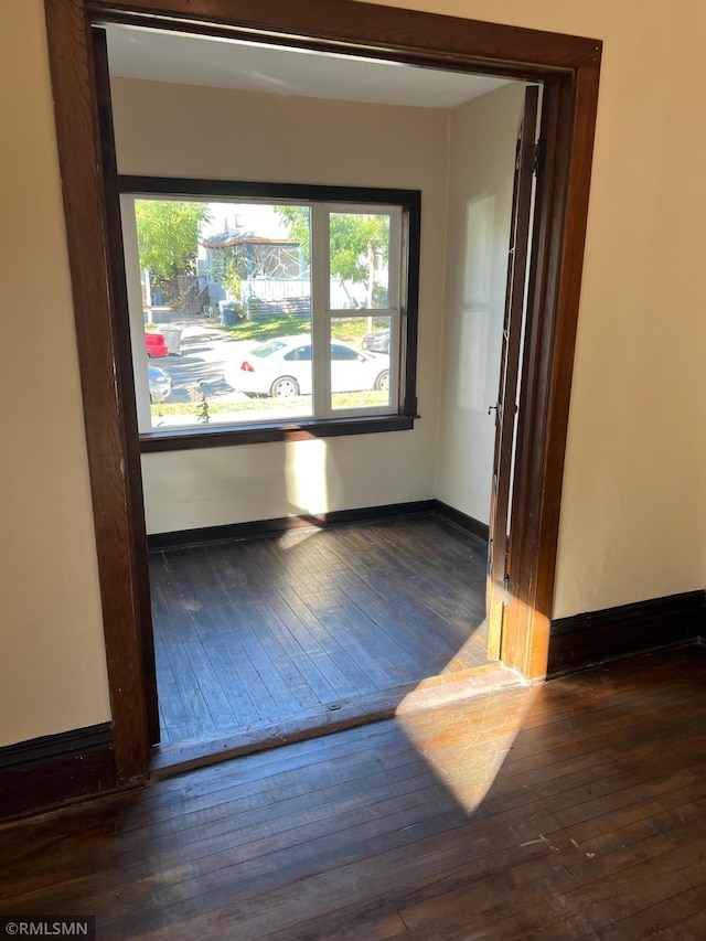 unfurnished room featuring dark hardwood / wood-style flooring