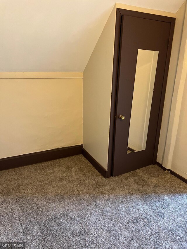 bonus room featuring carpet and lofted ceiling