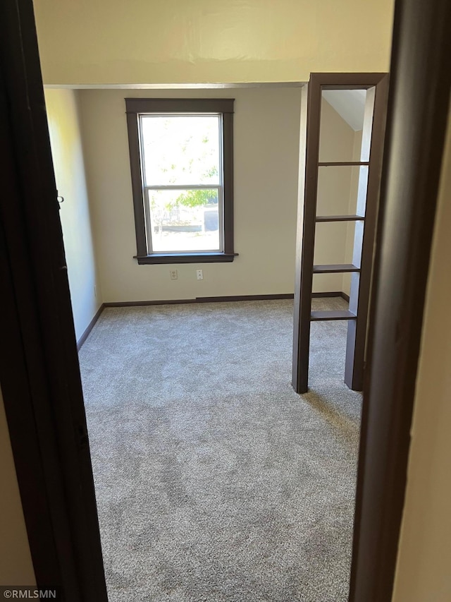 unfurnished room featuring light colored carpet