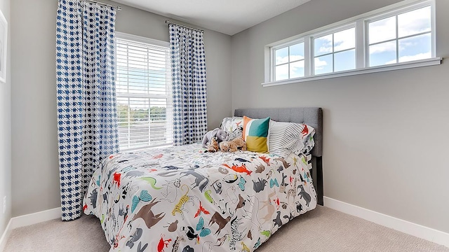 carpeted bedroom with multiple windows