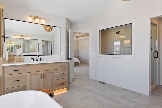 bathroom with vanity, independent shower and bath, and vaulted ceiling