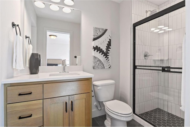 bathroom with vanity, tile patterned floors, toilet, and walk in shower