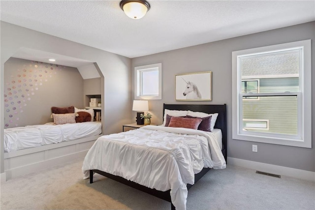 carpeted bedroom with a textured ceiling