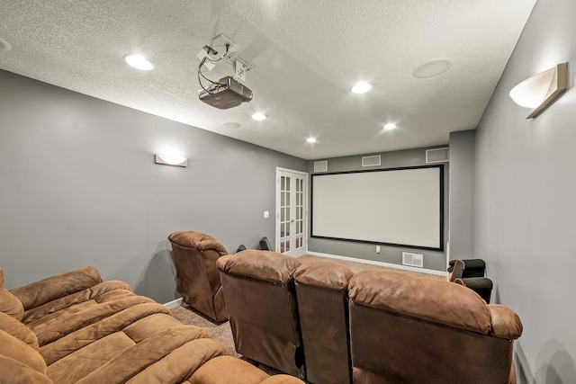 home theater room with a textured ceiling and carpet floors