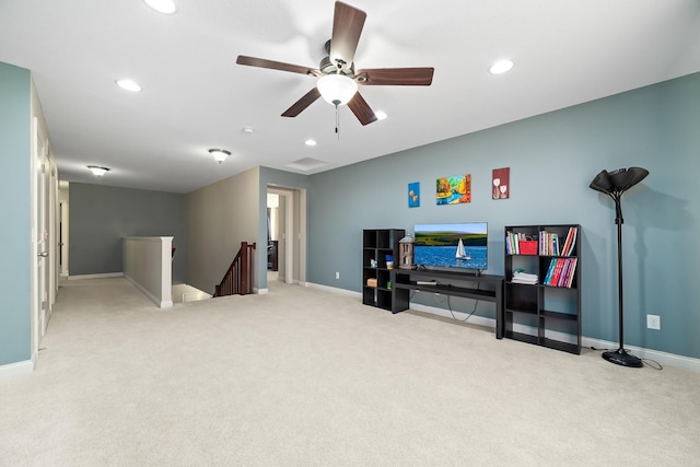 interior space featuring ceiling fan and light colored carpet