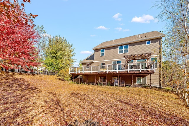 back of property featuring a pergola and a deck