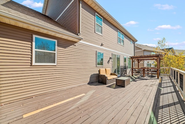 wooden terrace with a pergola and an outdoor living space