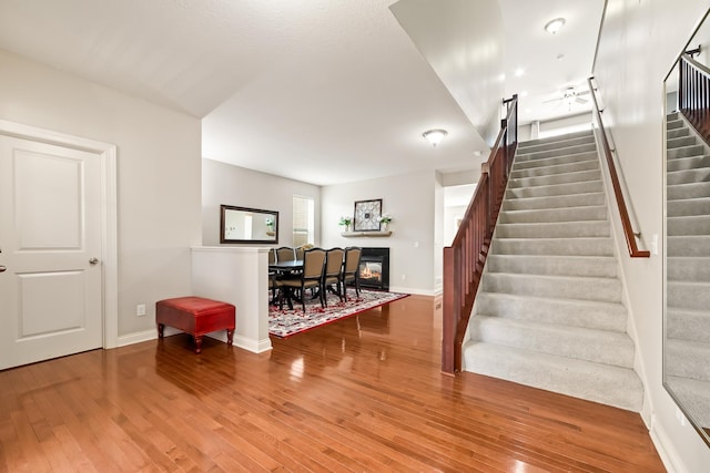 stairs with hardwood / wood-style floors