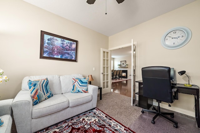 carpeted office space with ceiling fan and french doors