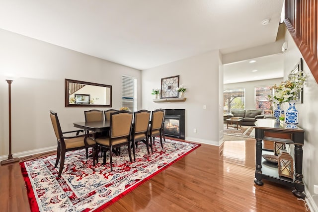 dining space with wood-type flooring