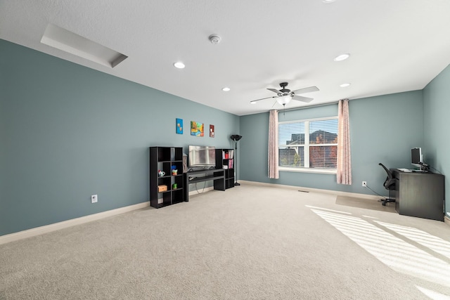 interior space with light carpet and ceiling fan