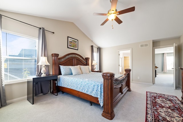 carpeted bedroom featuring ceiling fan, vaulted ceiling, and multiple windows