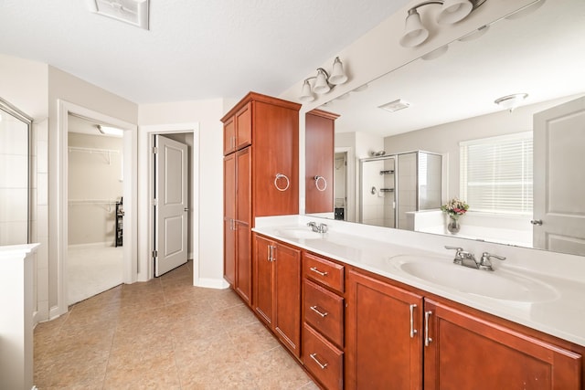 bathroom with vanity and a shower with shower door