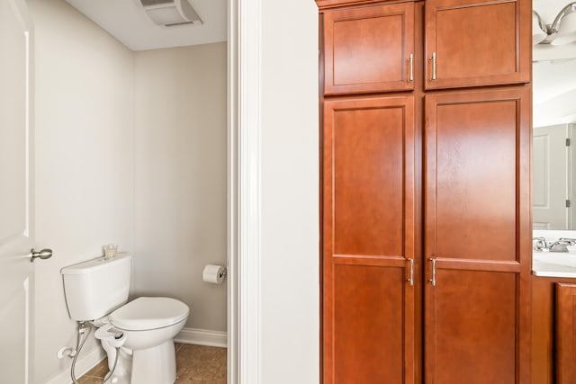 bathroom featuring tile patterned flooring, vanity, and toilet