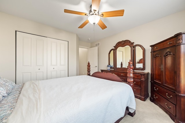 bedroom featuring light carpet, a closet, and ceiling fan