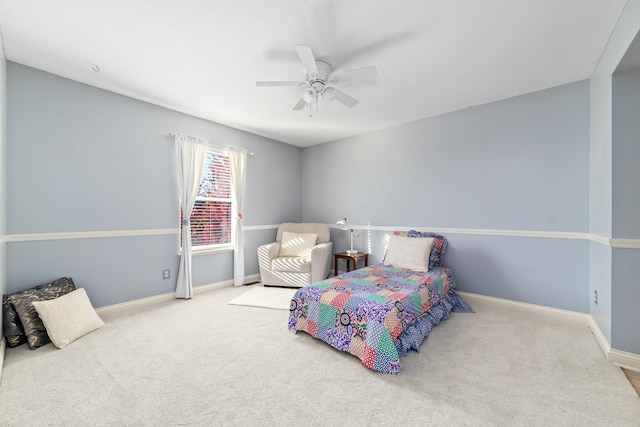 bedroom featuring ceiling fan and light carpet