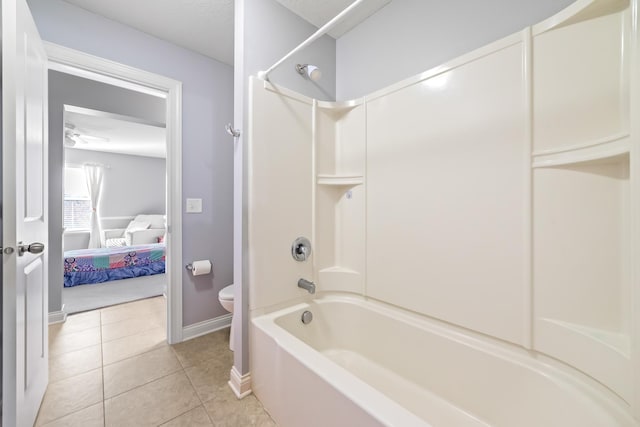 bathroom with tile patterned flooring,  shower combination, and toilet