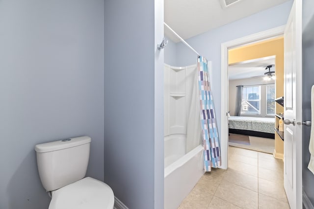 bathroom with tile patterned flooring, ceiling fan, toilet, and shower / bath combo with shower curtain