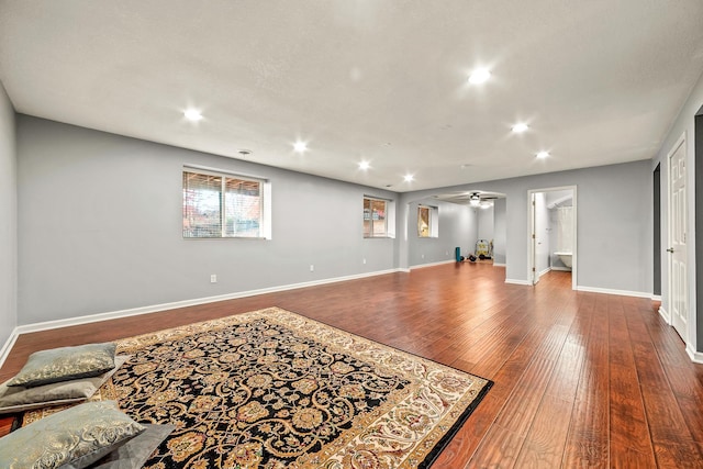 living room with wood-type flooring and ceiling fan