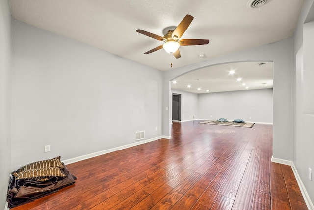 unfurnished living room with hardwood / wood-style floors and ceiling fan