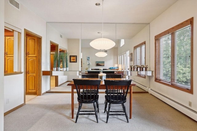 carpeted dining room with a baseboard radiator