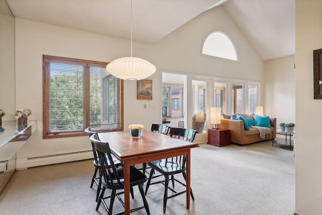 dining area featuring carpet floors, a baseboard radiator, and high vaulted ceiling