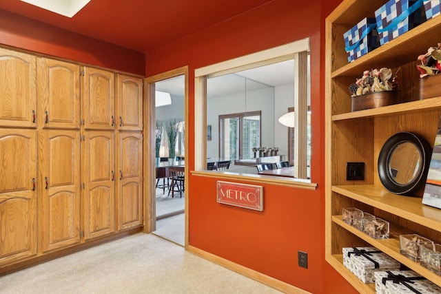 hall with light colored carpet