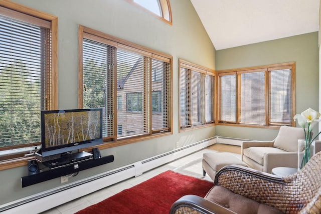 interior space featuring a wealth of natural light, lofted ceiling, and a baseboard heating unit