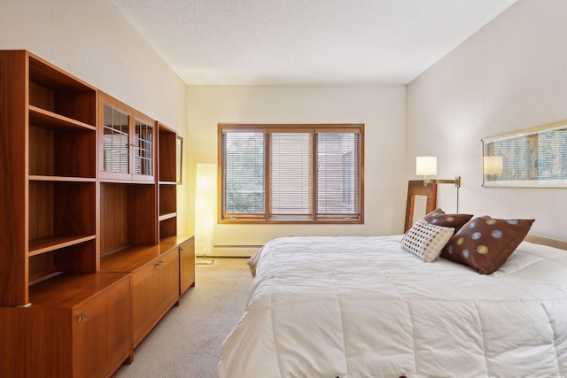 carpeted bedroom featuring a textured ceiling and baseboard heating