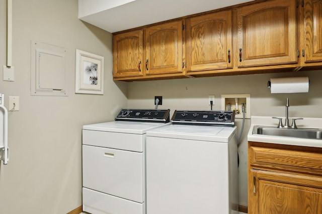 clothes washing area featuring cabinets, independent washer and dryer, and sink