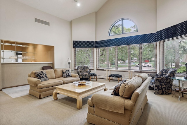 living room featuring light carpet and high vaulted ceiling