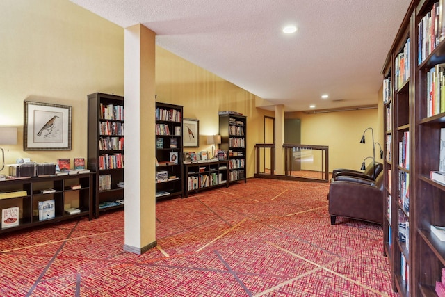 living area with carpet flooring and a textured ceiling