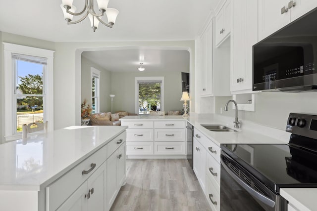 kitchen featuring white cabinets, a healthy amount of sunlight, stainless steel appliances, and sink