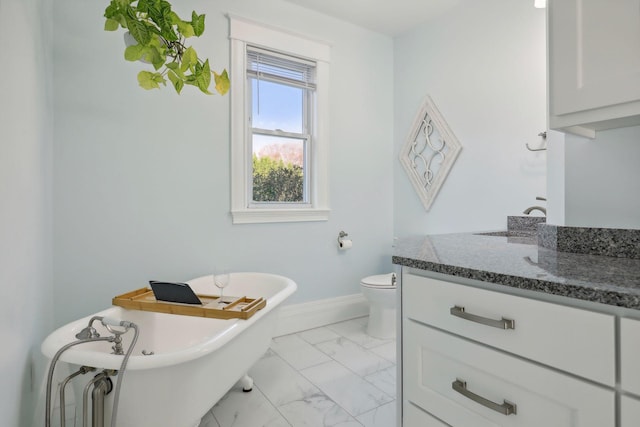 bathroom featuring vanity, a bathtub, and toilet