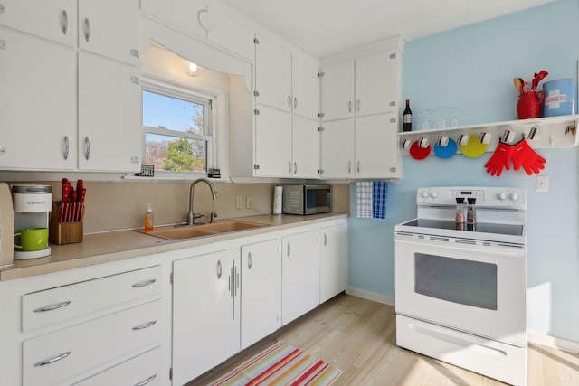 kitchen featuring white cabinets, white electric stove, sink, and light wood-type flooring