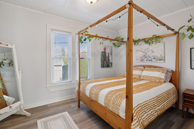 bedroom featuring ornamental molding and hardwood / wood-style flooring