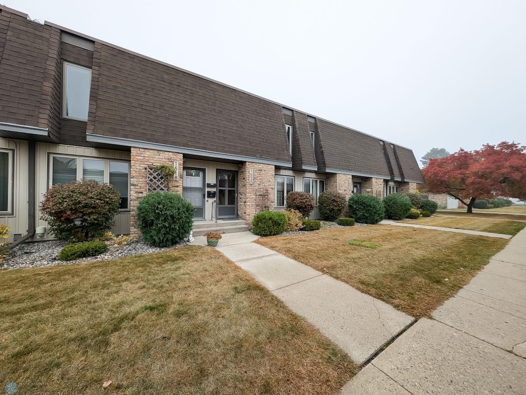 view of property featuring a front lawn