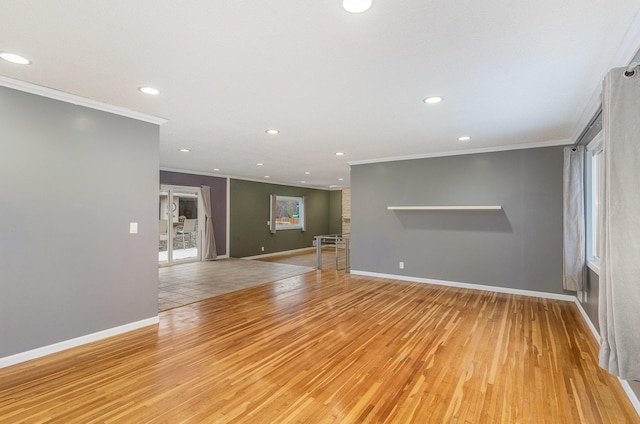 spare room with ornamental molding and light wood-type flooring