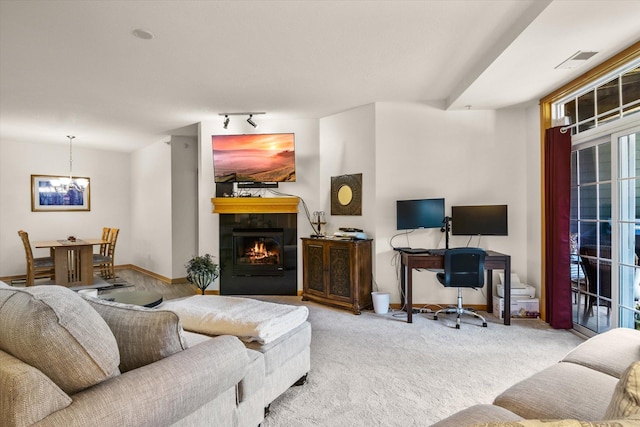 carpeted living room with track lighting and a tiled fireplace