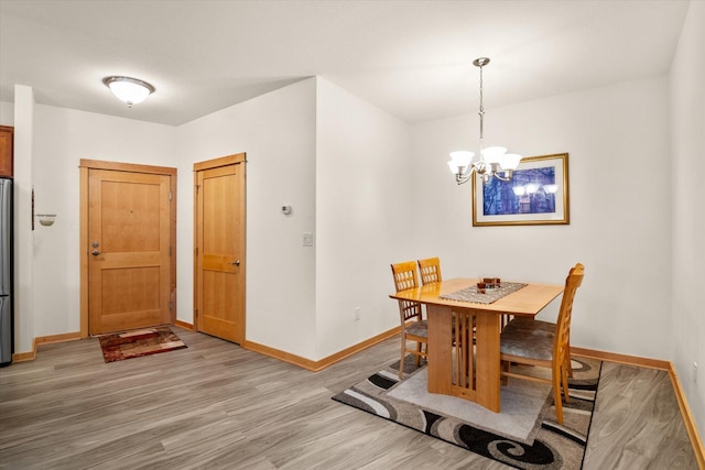 dining area featuring a notable chandelier and hardwood / wood-style flooring