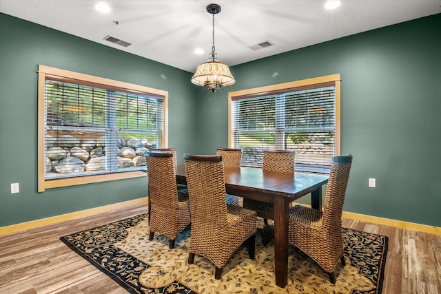 dining room with a notable chandelier, hardwood / wood-style floors, and a wealth of natural light