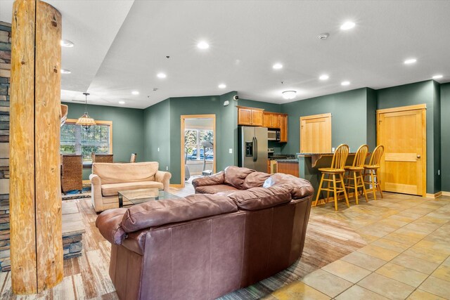 tiled living room with plenty of natural light