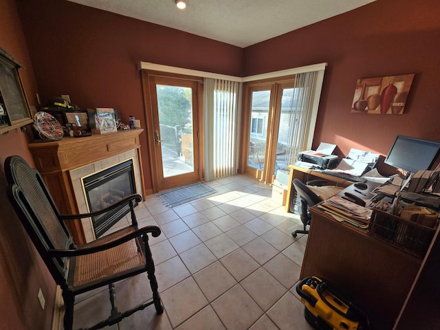 office space featuring a fireplace and light tile patterned floors