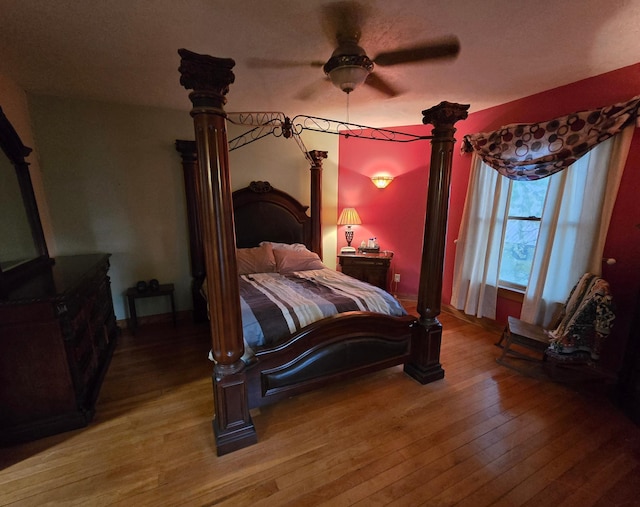 bedroom with ceiling fan and light wood-style floors