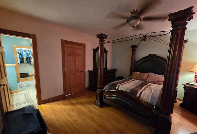 bedroom featuring ceiling fan, baseboards, and light wood-style flooring