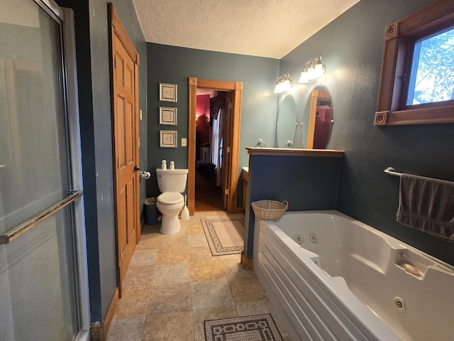 full bathroom featuring toilet, vanity, and a tub with jets