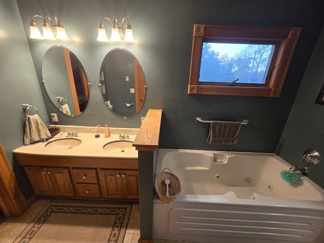 full bathroom featuring tile patterned flooring, a jetted tub, a sink, and double vanity