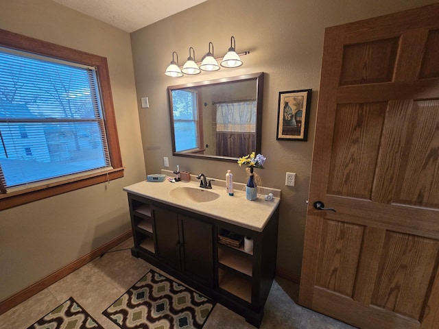 bathroom featuring a shower with curtain, baseboards, and vanity