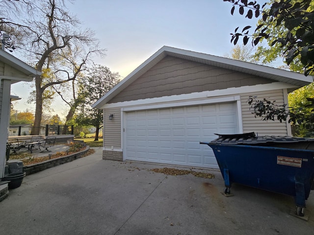 garage at dusk with a detached garage