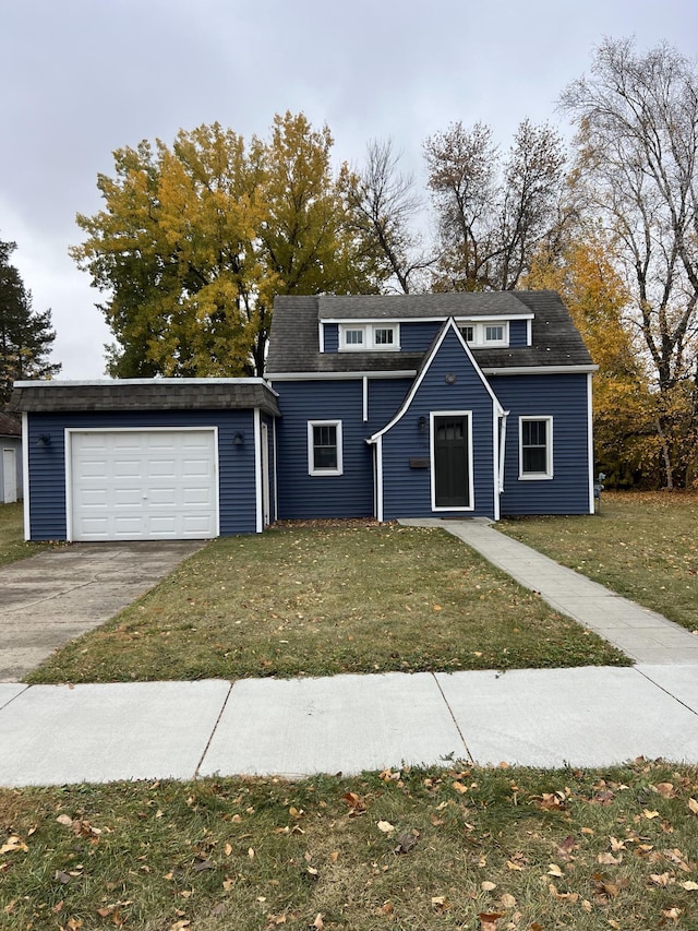 front facade with a garage and a front lawn